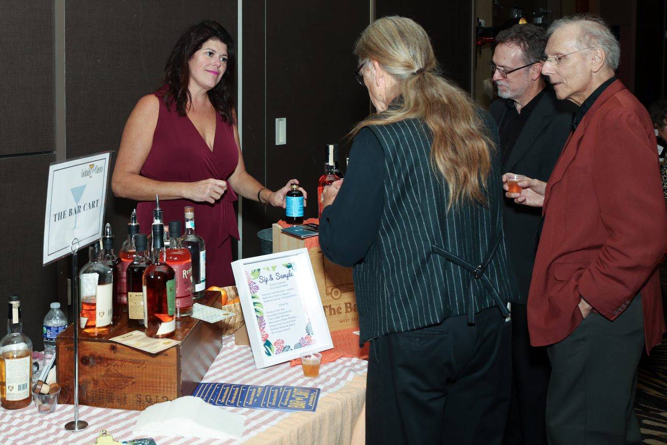 The Bar Cart staff interacting with guests from Cocktails & Classics.