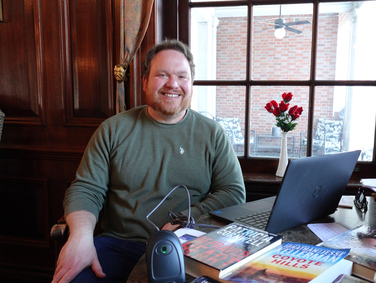 Senior Outreach Coordinator Ryan Yanchocik at library checkout