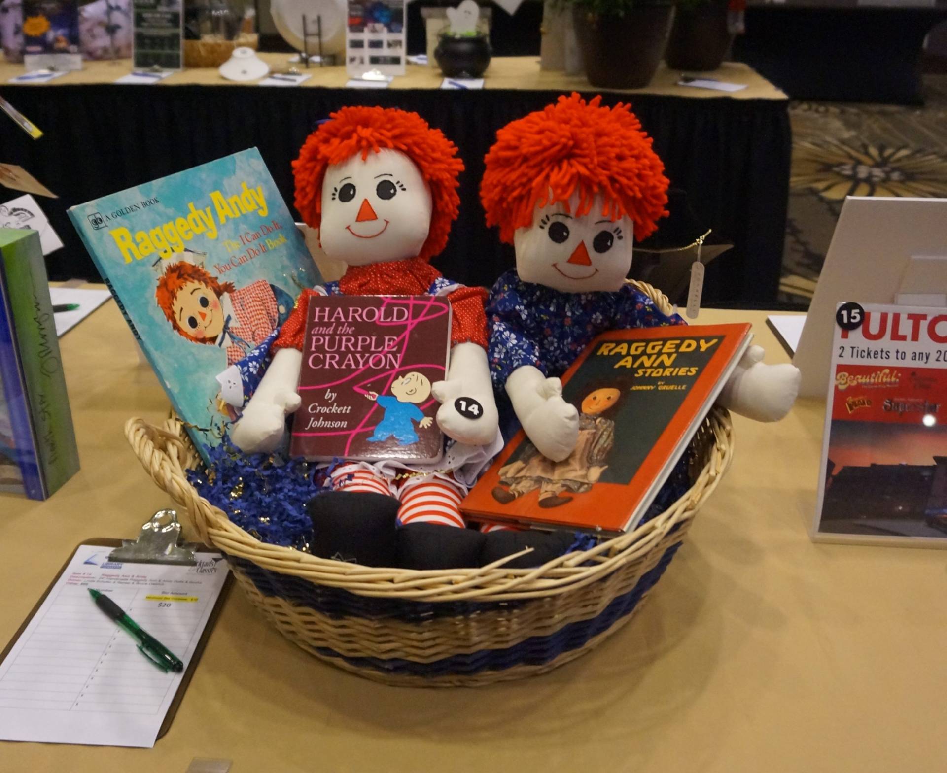 basket of Raggedy Ann and Andy dolls and childrens books