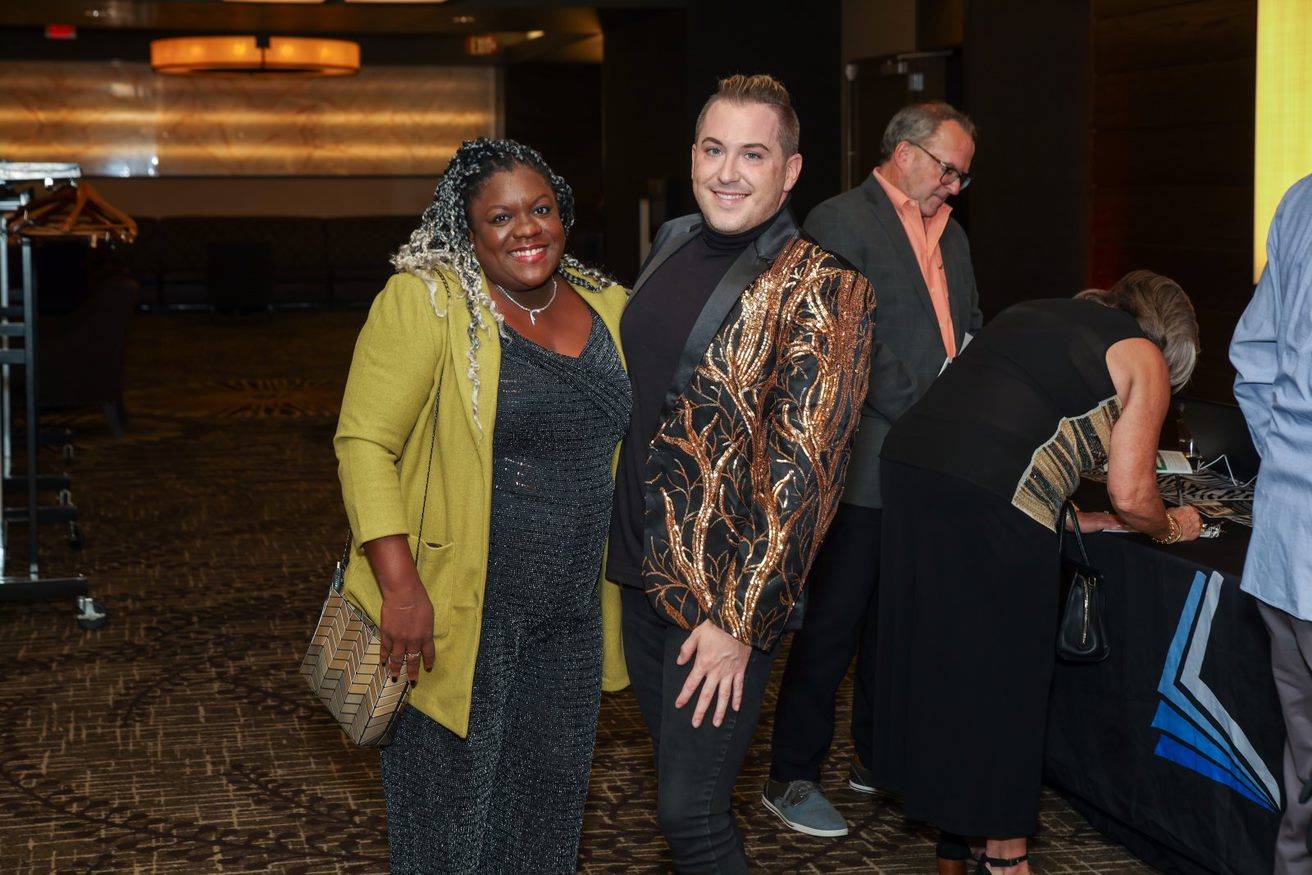 two guests posing at cocktails and classics