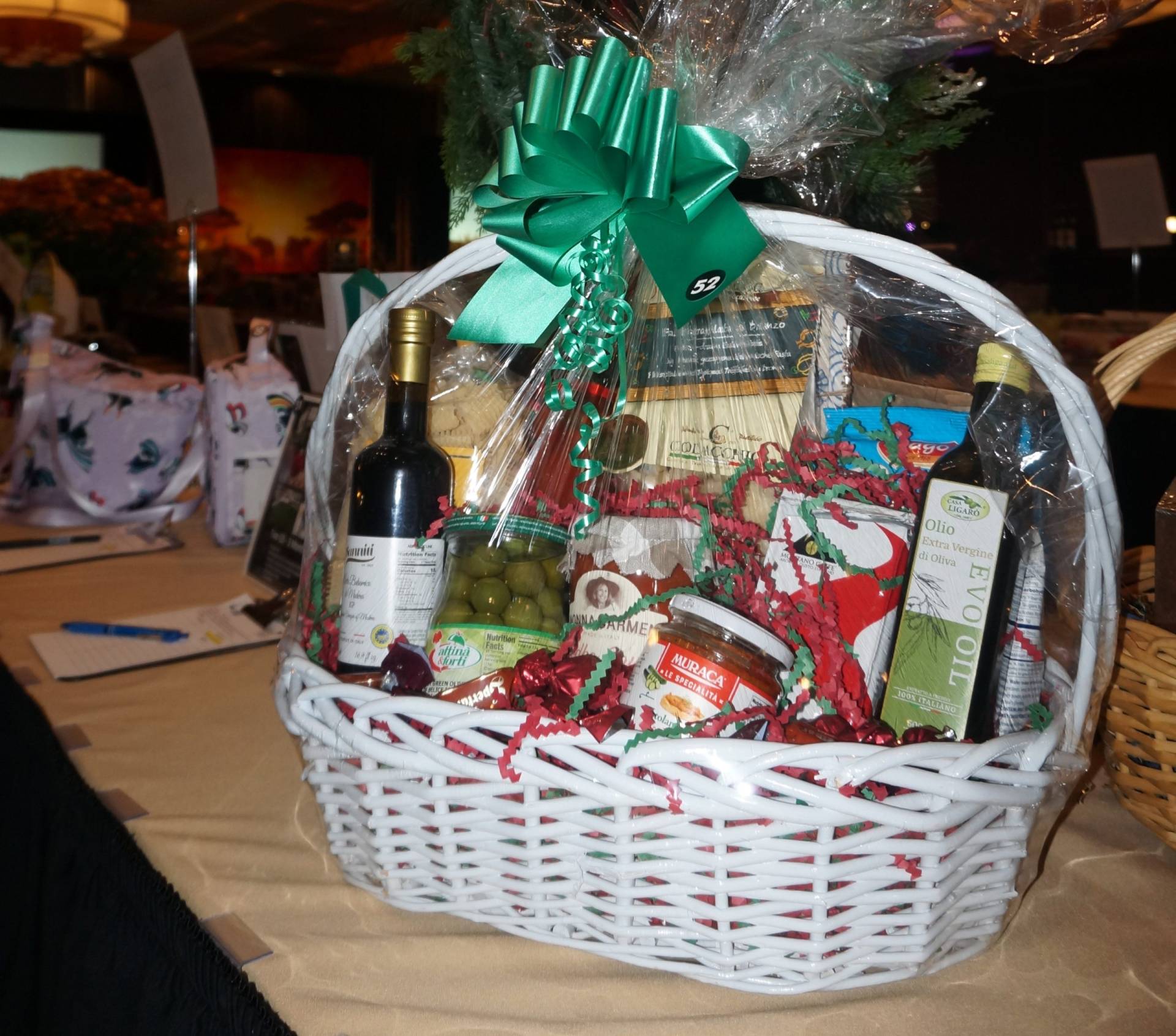 basket of [asta, sauce, oilive oil, olives, and other italian food garnishes