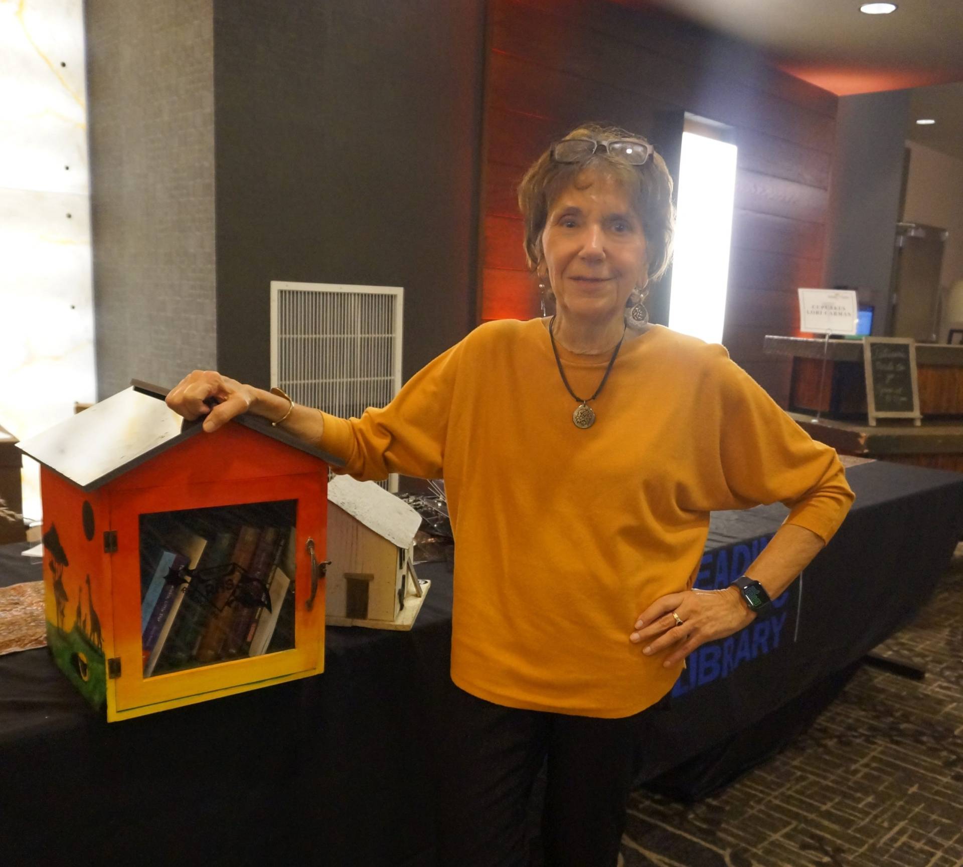 winner of little free library in a yellow sweater